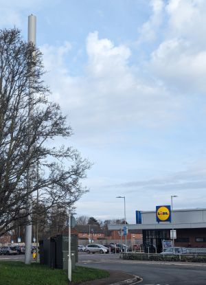 Image depicts a Cornerstone mast next to a LIDL supermarket.