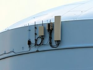 A close view of a standard T-Mobile macro setup side-mounted on a water tower.